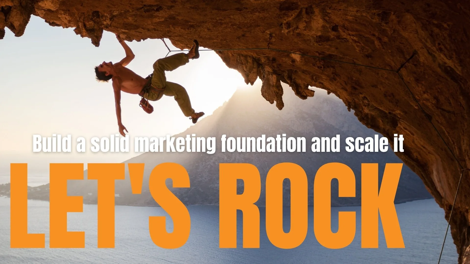 Climber on a cliff overhang with the words Let's ROCK, build a solid marketing foundation and scale it